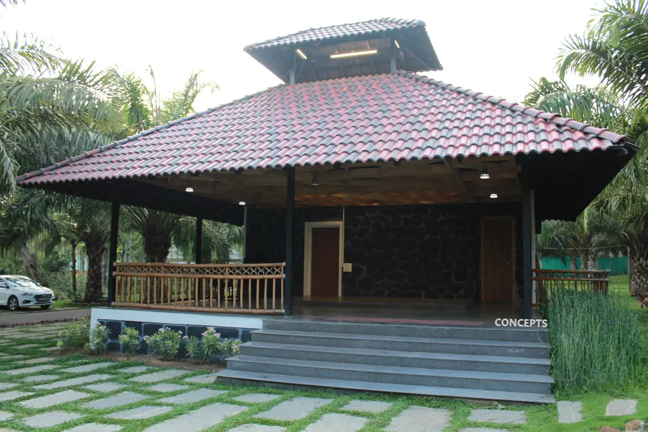 Open-sided pavilion with tiled roof at Palm Era Resorts, Coorg